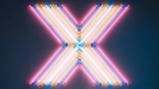 Vibrant neon X sign with colorful reflections on a dark floor background.